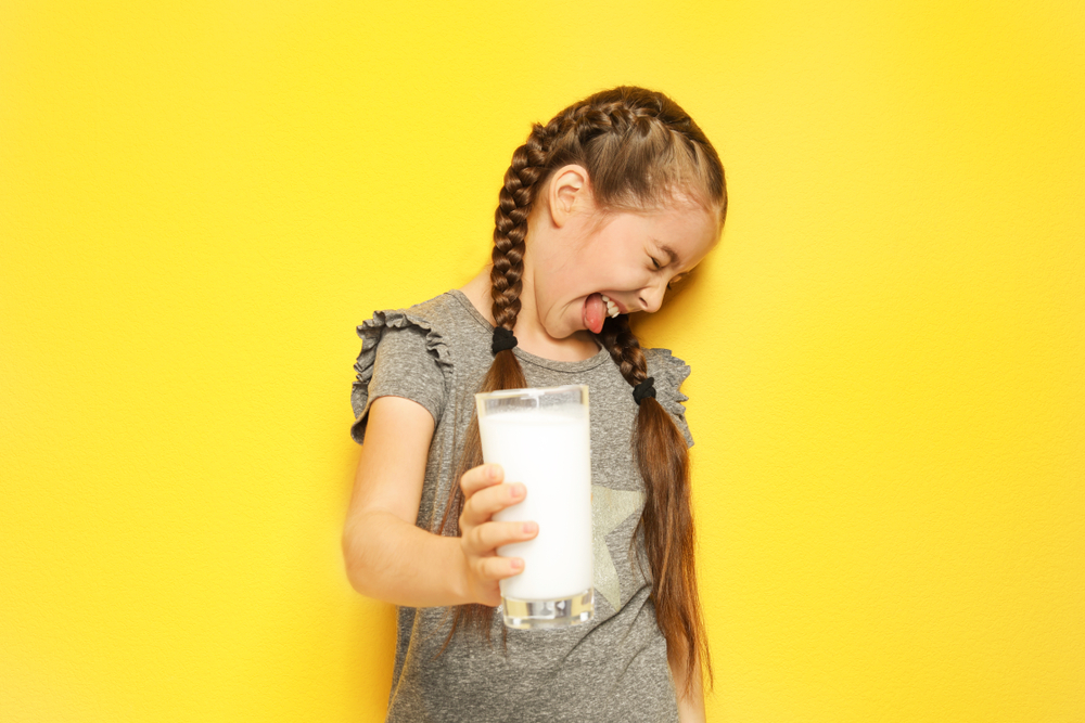 Little,Girl,With,Dairy,Allergy,Holding,Glass,Of,Milk,On