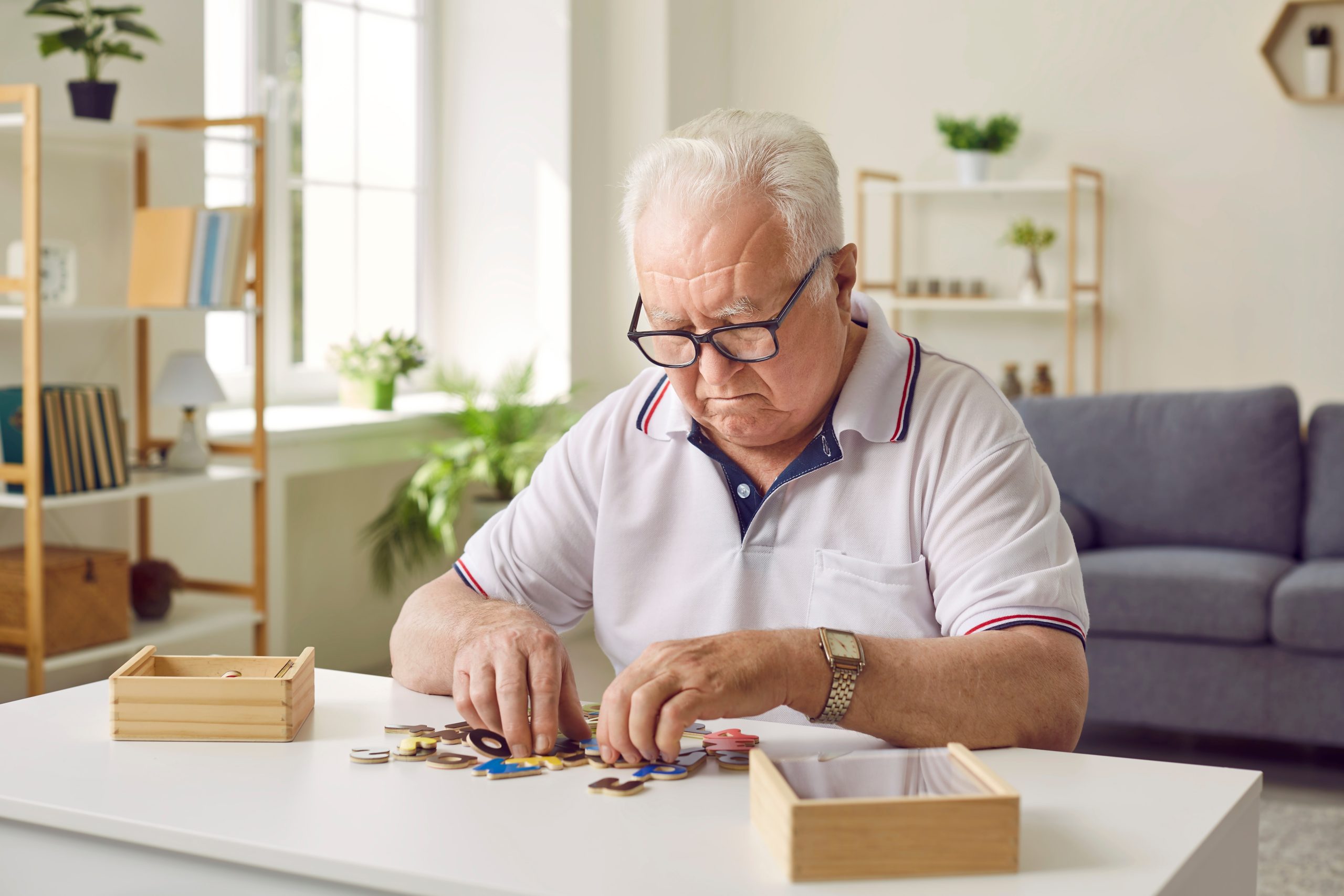 Portrait,Of,A,Senior,Elderly,Sad,Gray-haired,Man,Collecting,Wooden