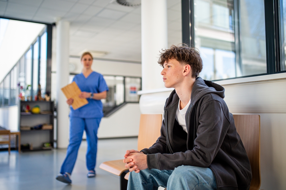 Teenage,Boy,Waiting,Alone,In,Hospital,Waiting,Area,Before,Medical