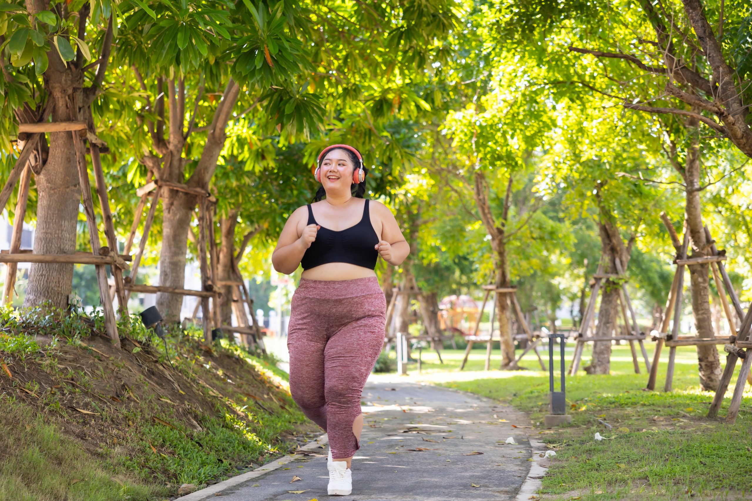 Bride Running outdoor woman. beautiful young chubby overweight woman in sportswear doing exercise outdoors at park. fitness sport club, body and health care. Activity