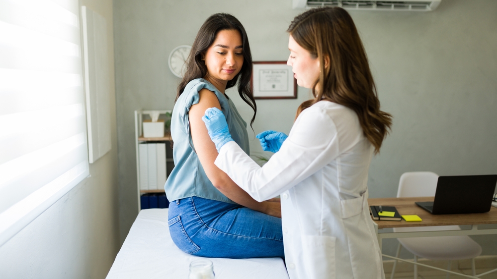 Young,Hispanic,Woman,Is,Getting,Vaccinated,By,A,Professional,Medical